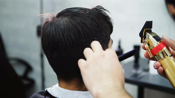 Closeup of Barber Cutting Client Hair with Razor Electric Slow Motion
