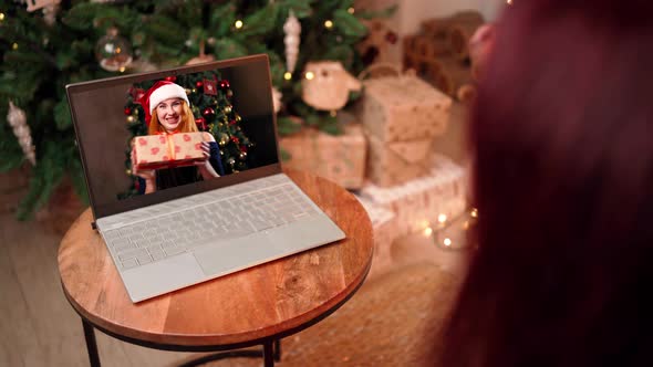 Two Girlfriends Celebrate Christmas with Video Call Using Laptop Social Distance