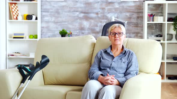 Portrait of Senior Woman in Nursing Home Sitting on the Couch