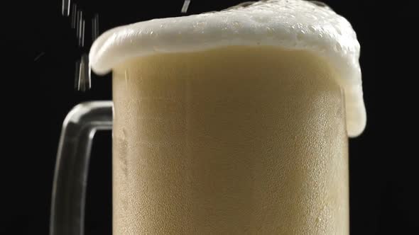 Beer Pouring in Glass, White Frothy Foam Flowing Over, Craft Brewery, Alcohol