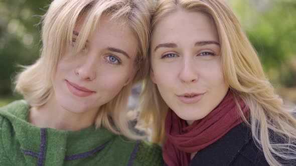 Portrait of Two Caucasian Girlfriends Looking at the Camera Smiling