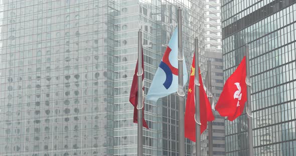 China and Hong Kong flag over business office building