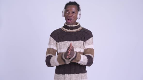 Young Happy African Man Clapping Hands Ready for Winter