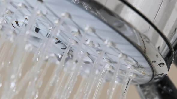 Macro Shot of Water Drops Flowing From Shower Head in Bathroom Slow Motion