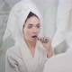 Young Beautiful Woman in the Bathroom Brushing Her Teeth in Front of the Mirror - VideoHive Item for Sale