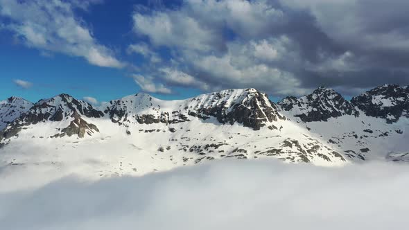 Snow Capped And Foggy Mountains