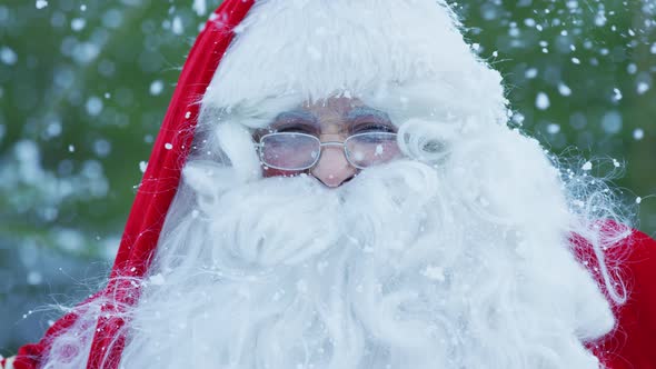 Close up of Santa Claus on a snowfall alt
