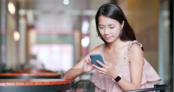 Woman use of smart phone in outdoor cafe