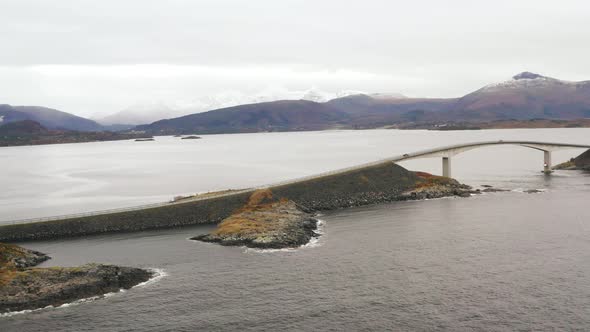 Scenic View Of The Long Narrow Bridge Of Storseisundet In Norway In A gloomy Afternoon - aerial shot