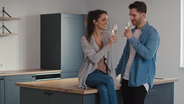 Couple making toast for  house ownership with a glass of champagne.