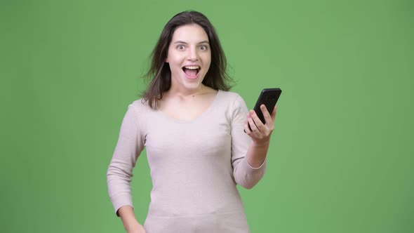 Young Happy Beautiful Woman Using Phone and Giving Thumbs Up