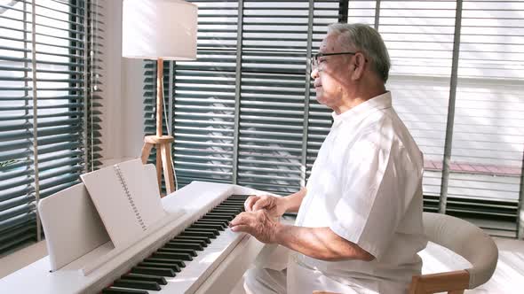 Middle-aged male enjoying a unique moment while playing the piano.