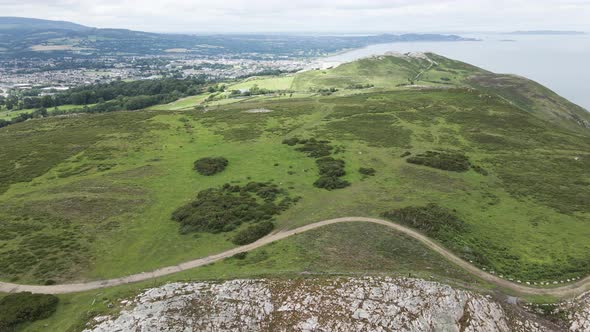 The Lush Bray Head Mountain In Wicklow, Ireland With Nice View Of Bray Town Landscape - aerial
