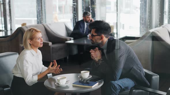 Business Partners Discussing Cooperation in Cafe Talking During Lunch Break