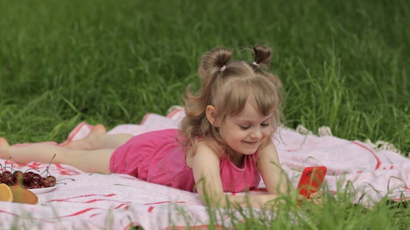 Weekend at Picnic. Girl on Grass Meadow Play Online Games on Mobile Phone. Social Network, Chatting