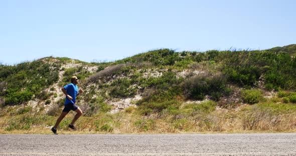 Triathlete man jogging in the countryside road