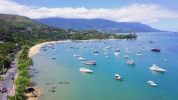 Aerial view of a large number of vessels moored near the maritime coast.