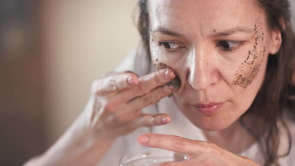 Applying Coffee Scrub On Cheekbones