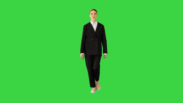 Young Woman in Office Suit Walking Adjusting Her Jacket on a Green Screen Chroma Key