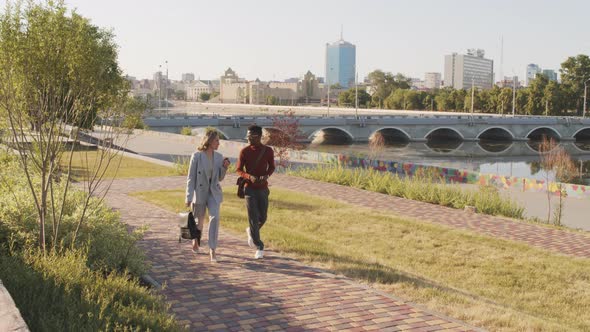 Interracial Business Couple Walking Outdoors in Summer