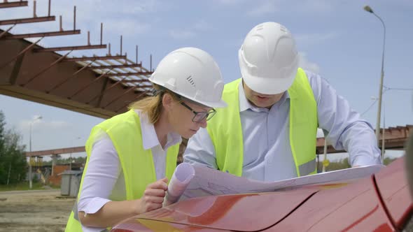 Builders Discuss a Project at A Construction Site