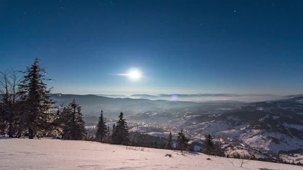 Fog Moving Over the Mountain in Winter with a Starshaped Sky