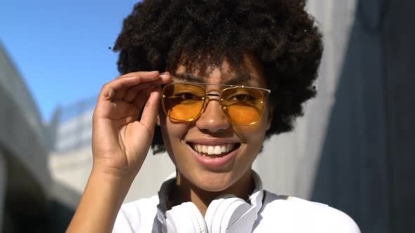 Cheerful Young Woman Taking Off Glasses and Winking Into Camera, Self-Confidence