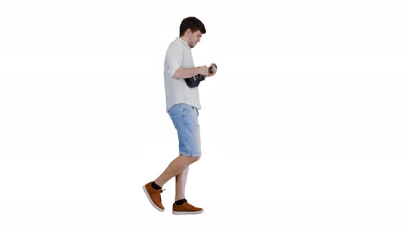 Young Man Playing Ukulele While Walking on White Background