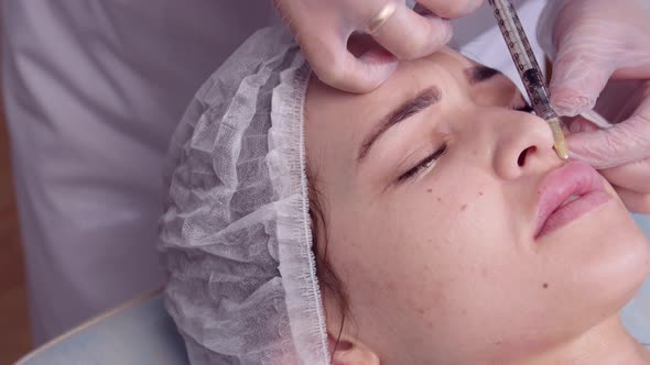 Anti Aging Concept, Young Woman Getting Facial Injections at Beauty Clinic