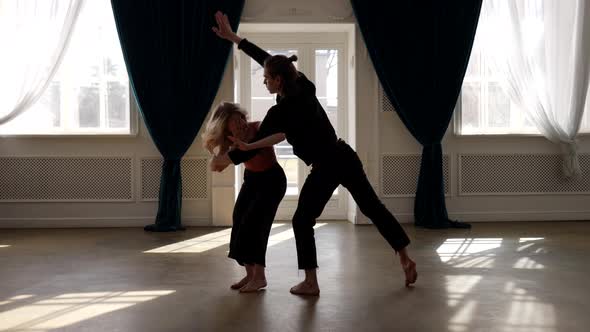 a Young Barefoot Couple is Dancing in a Spacious Bright Room