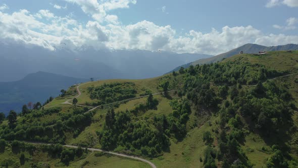 Paragliding in the Mountains Against the Backdrop of a Beautiful Mountain Landscape on a Sunny Day