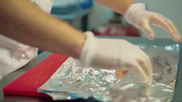 Cook Wraps the Pickled Meat in Foil for Subsequent