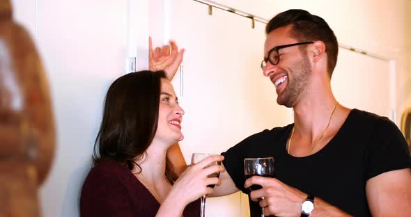 Couple interacting with eachother while drinking red wine