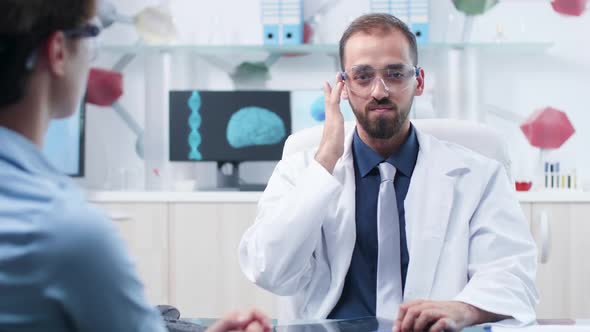 Caucasian Physician with AR Goggles Showing Something To a Patient