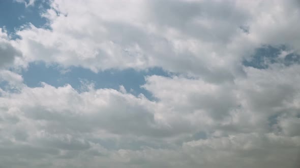 Sun Rays Shining Through Cloudy Sky With Fluffy Clouds During Dust Storm