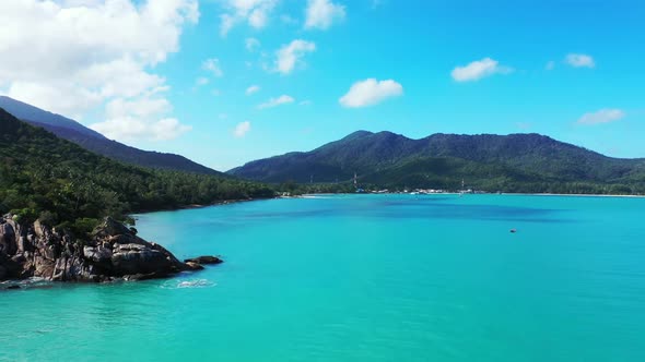 Aerial panorama of exotic island beach wildlife by transparent lagoon and white sandy background of 