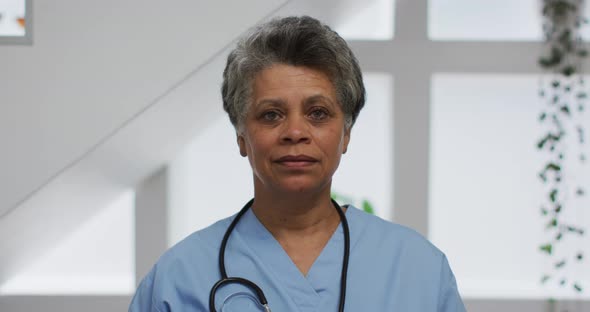 Portrait of senior african american female doctor looking at camera and smiling
