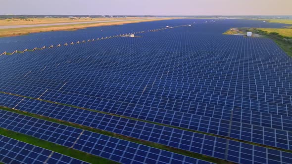 Aerial View of Solar Panels Stand in a Row in the Fields Power Ecology Innovation Nature Environment