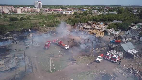 Firefighters Are Extinguishing Fire in Village, Fire Engines, Aerial Shot