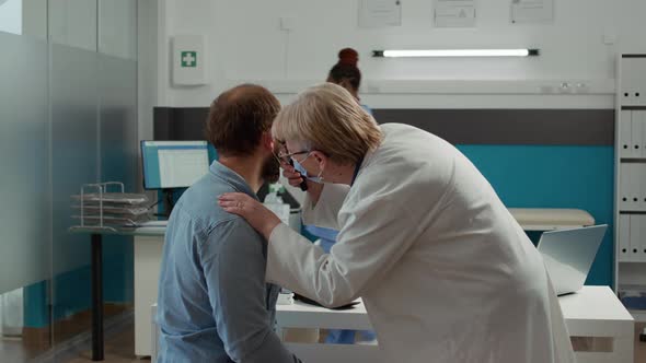 Doctor Otologist Examining Ear Infection of Patient with Otoscope