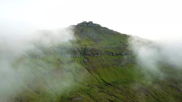 Aerial View of Amazing Mist Faroese Nature Foggy Green Hills and Rocky Cliffs