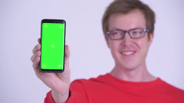 Face of Happy Young Handsome Man Showing Phone