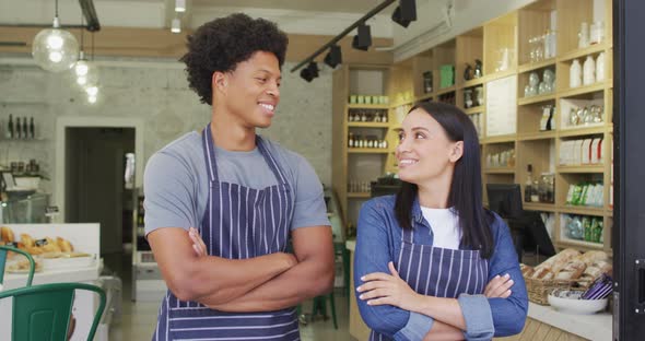 Animation of happy diverse female and male waiters at coffee shop