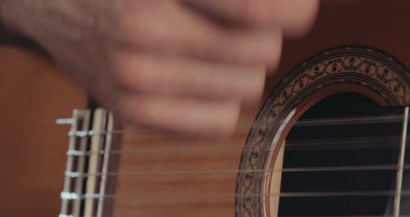 Musician playing acoustic guitar in a recording studio