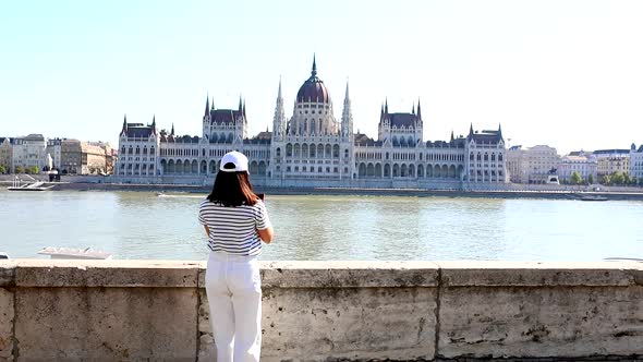 Woman Traveler Taking Picture of Budapest Parliament Building