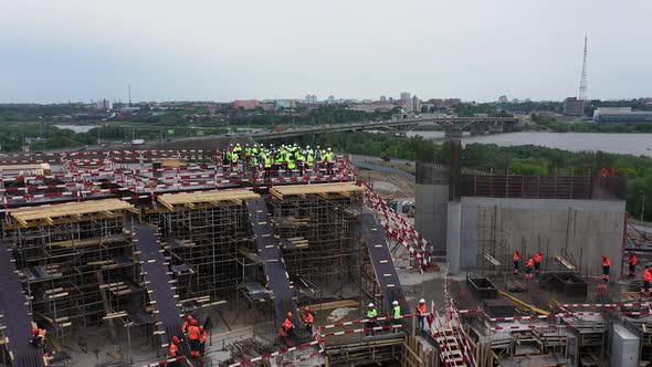 Workers in Bright Uniforms on Floors of Sports Stadium alt