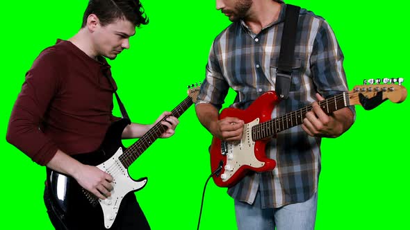 Male musicians playing guitar