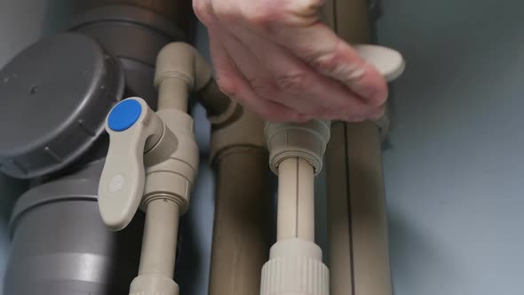 the Plumber's Hand Opened the Valves of the Plastic Pipelines in the Bathroom