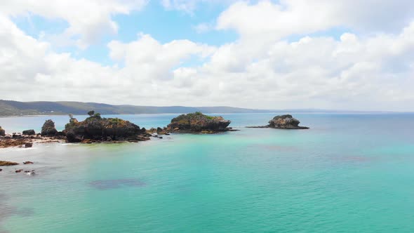 Aerial shot rising up to the view of small islands on the southern Australian coastline.