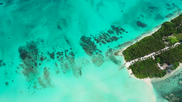 Tropical aerial copy space shot of a white sandy paradise beach and blue ocean background in colourf